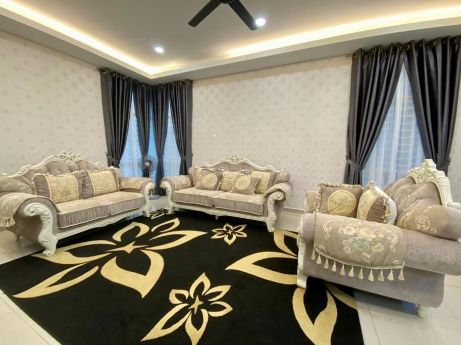 a living room with two couches and a rug at 13StayCation Islamic Homestay in Melaka