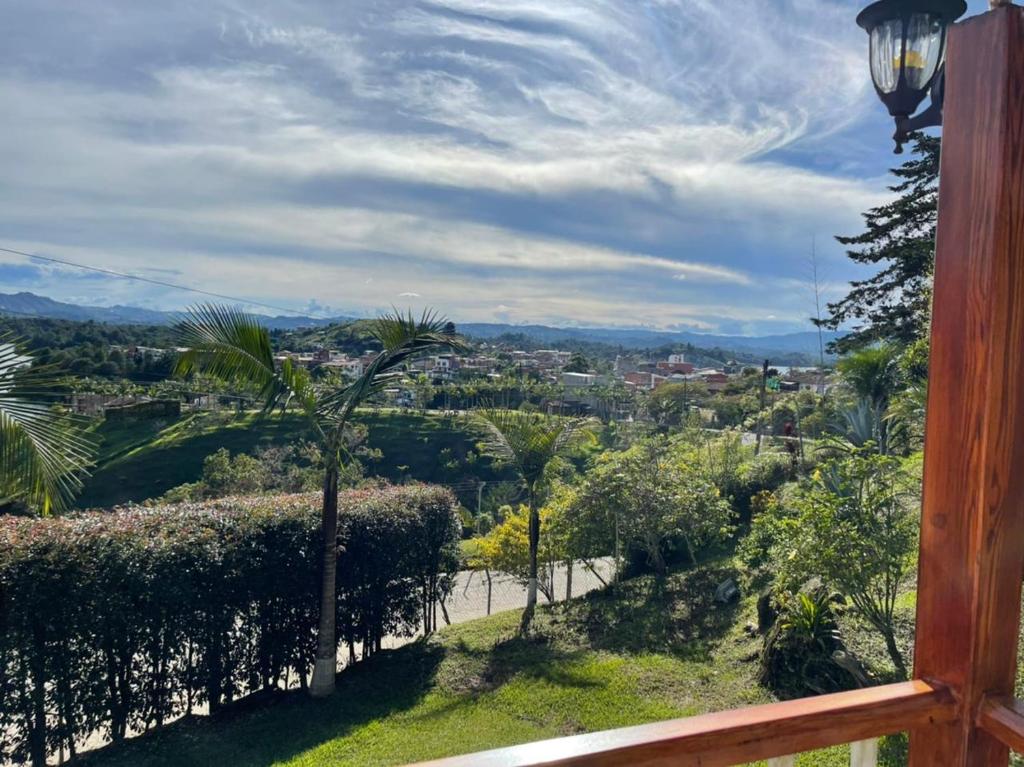 a view of a city from the balcony of a house at Finca-hotel Montecarlo Guatape by Hope in Guatapé