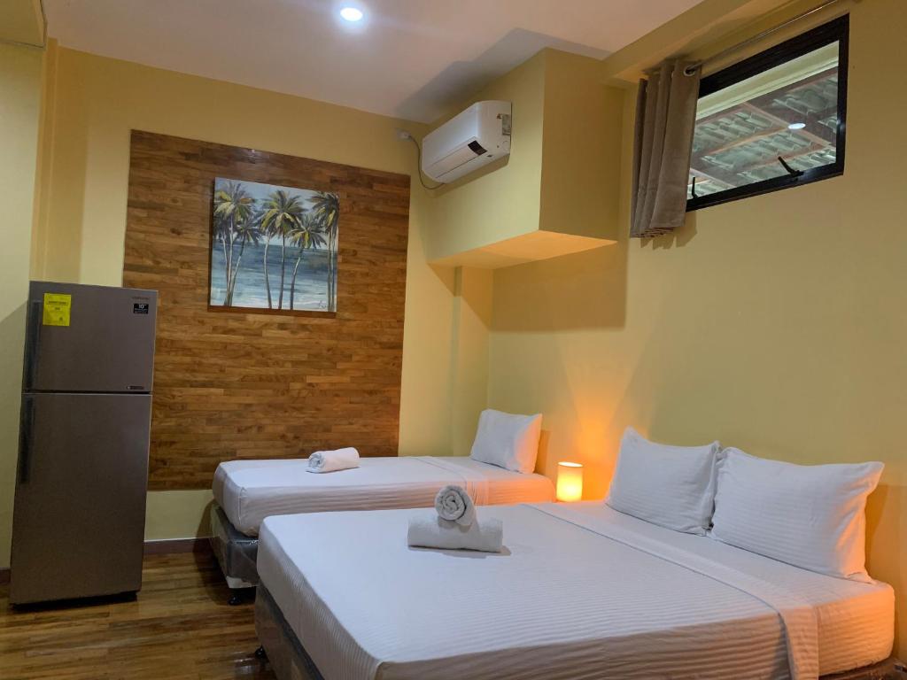 Postel nebo postele na pokoji v ubytování Mabini Hotel