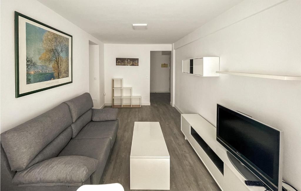 a living room with a couch and a flat screen tv at 3 Bedroom Awesome Apartment In Estepona in Estepona