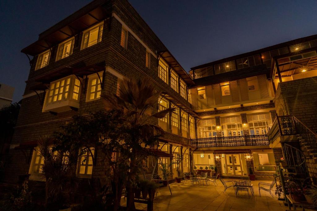 a large building with windows and a courtyard at night at Sajjan Niwas in Udaipur