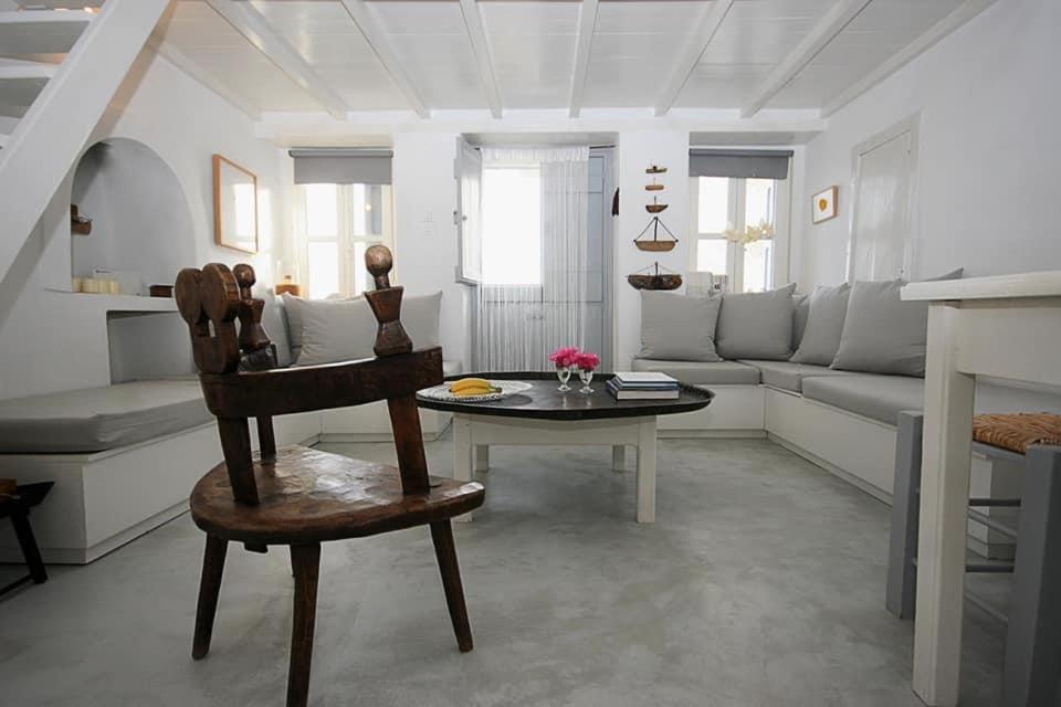 a living room with a table and a couch at The Pulse Residence Astypalea in Astypalaia