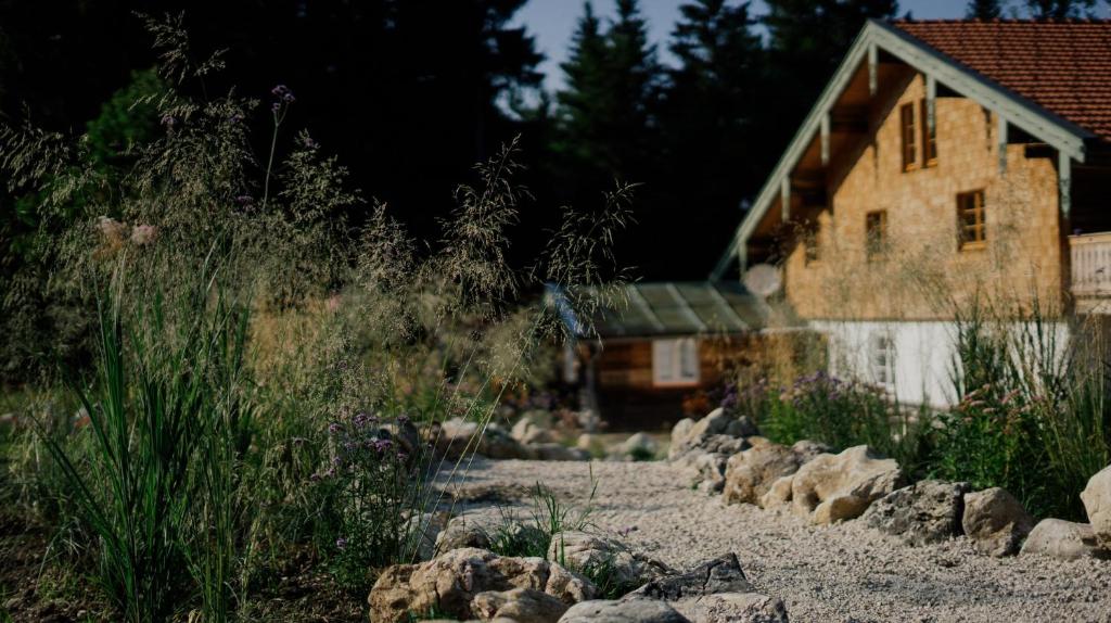 a house with a gravel path in front of a house at STUBN in der Frasdorfer Hütte in Frasdorf