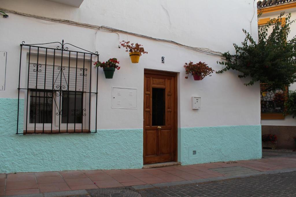 un edificio blanco con puerta y puerta en La Casita de Mari, en Estepona