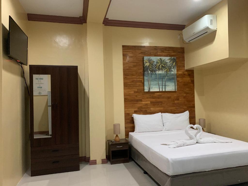 Postel nebo postele na pokoji v ubytování Mabini Hotel