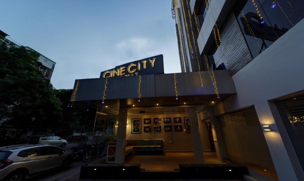 a building with a one city sign on top of it at Upar Hotels Cinecity Kodambakkam RAGHAVENDRA MANDAPAM in Chennai