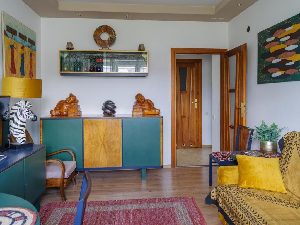 One&Only Saska Kępa Apartment في وارسو: غرفة معيشة مع أريكة وخزانة زرقاء
