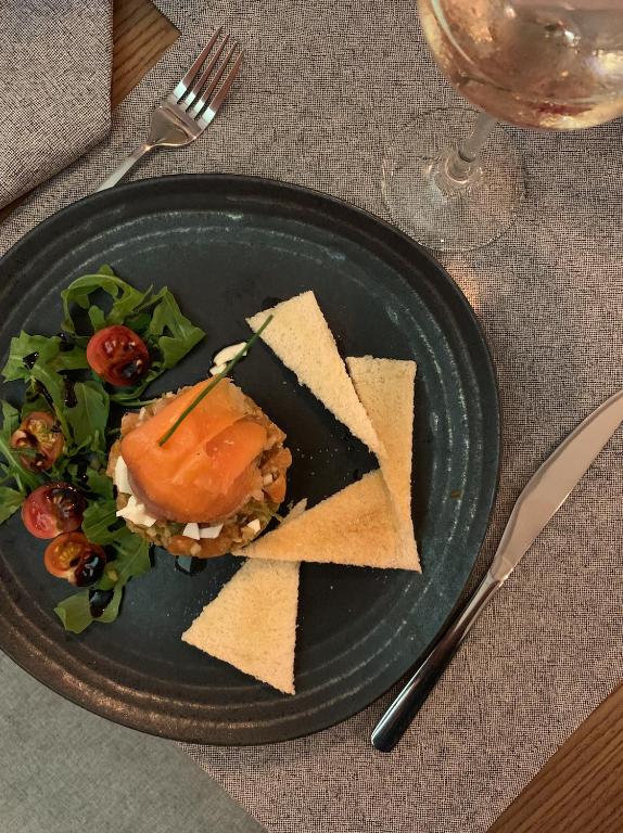 a plate with a sandwich and chips and a salad at La Serena Boutique Hotel & Wellness - Altea in Altea