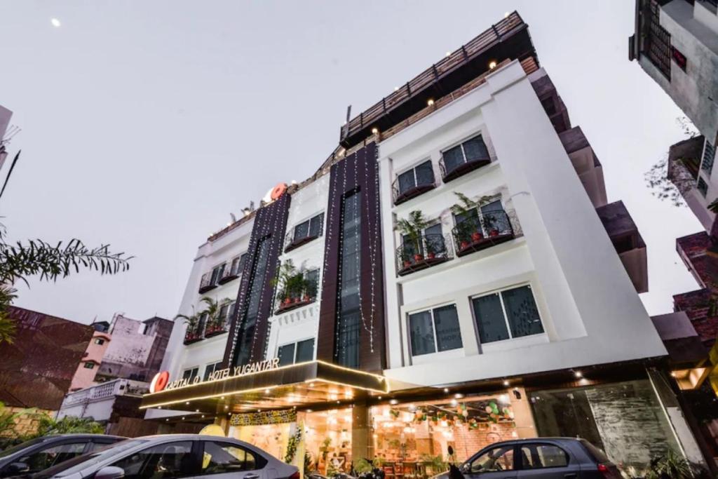 a building with cars parked in front of it at Hotel Yugantar & Banquets in Allahābād
