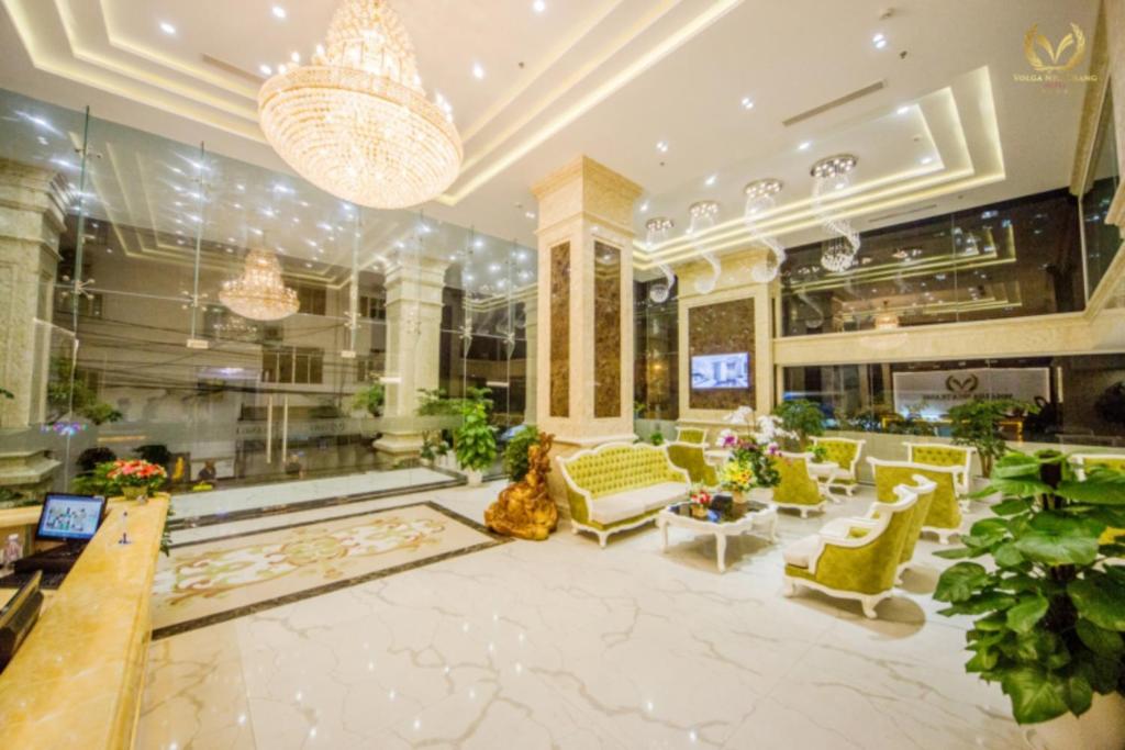 a lobby of a hotel with yellow and white furniture at Putin Hotel Nha Trang in Nha Trang