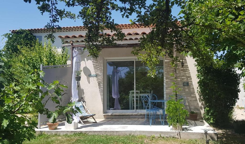 a small house with a porch and a blue chair at Mas Nina Rosa in Mazan