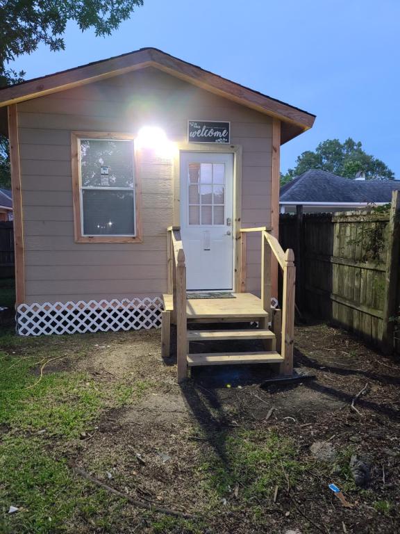 a tiny house with a door and a porch at JAMMS tiny home in Baton Rouge