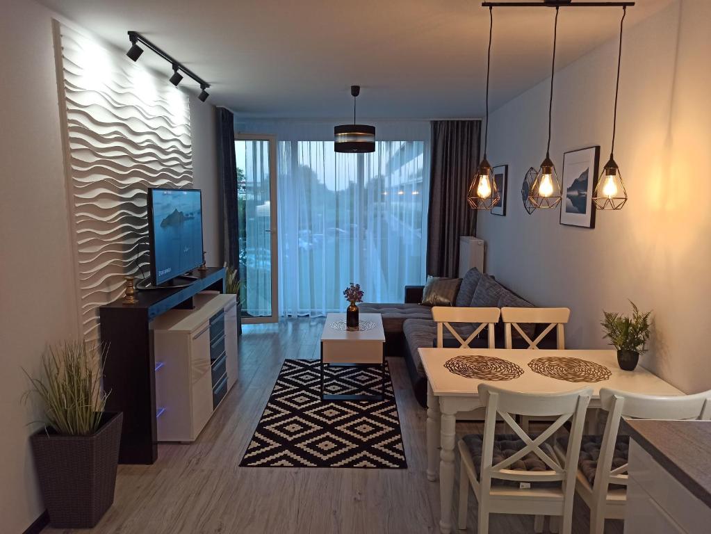 Televízia a/alebo spoločenská miestnosť v ubytovaní Apartament Czarna Perła