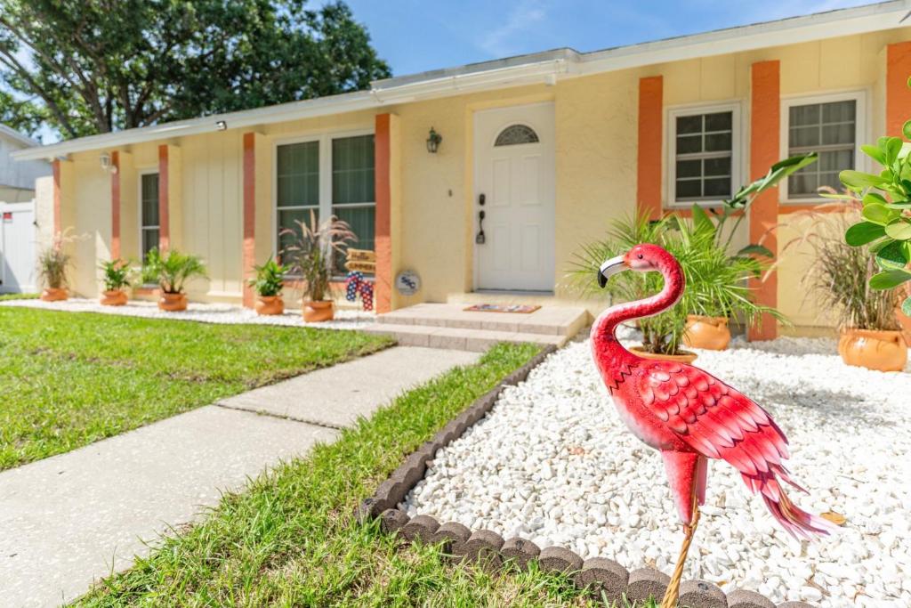 a statue of a red bird in front of a house at The Flamingo*4bed*pool*jacuzzi*foosball in Valrico