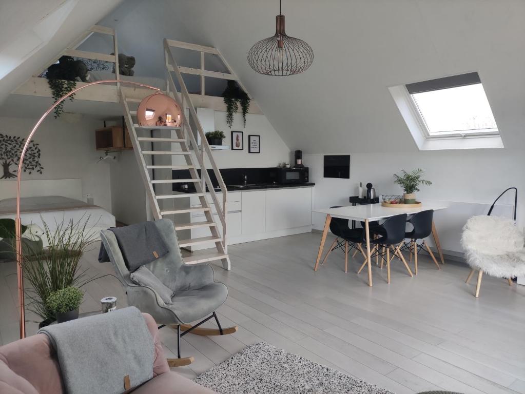 a living room with a loft bed and a table and chairs at *** Biezoe *** in Brakel