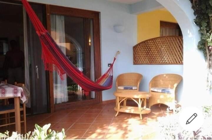 a patio with a hammock in a house at Halcyon Residence in Santa Maria