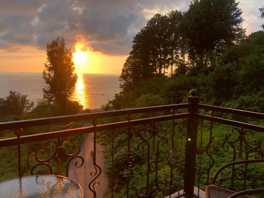a view of the ocean from a balcony at sunset at Villa Kolkhi in Kvariati