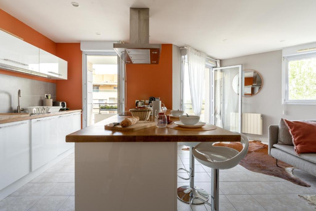 a kitchen with an island in the middle of a room at SIROCCO - Bel appartement avec extérieur proche des plages in Marseille