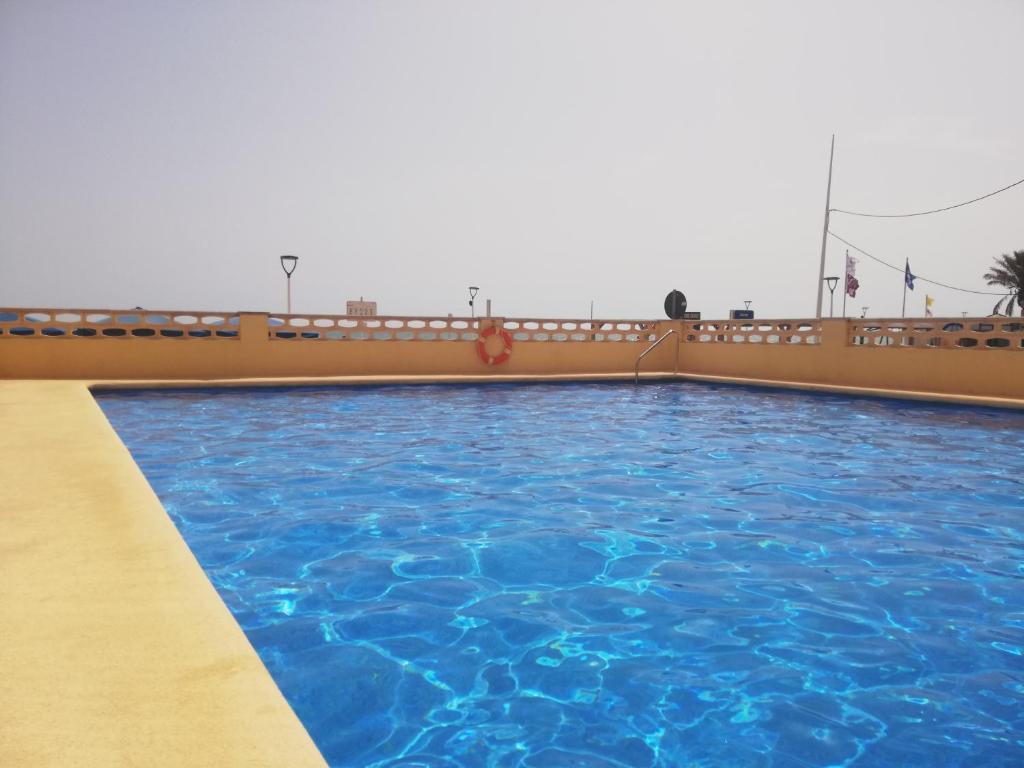 a swimming pool on a cruise ship at Acogedor estudio con vistas al mar 1ªLínea in Bellreguart