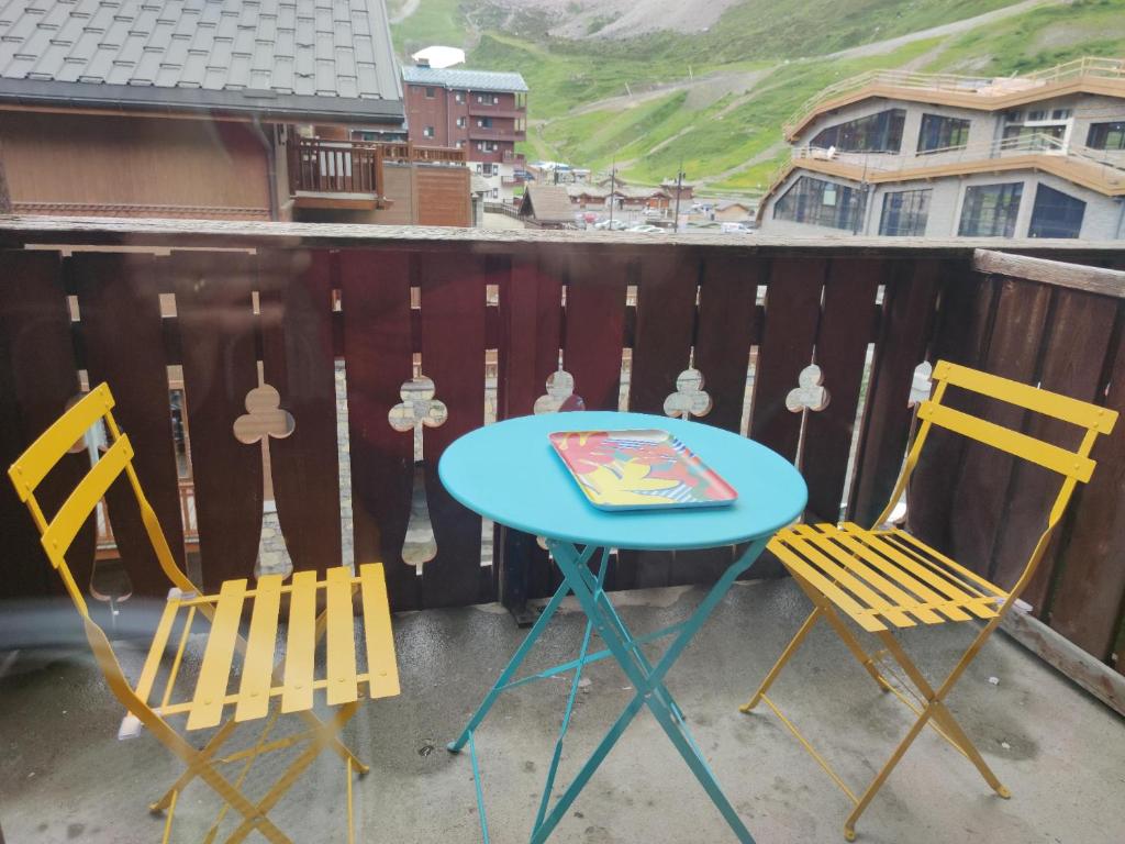 a blue table and two chairs on a balcony at CHALET CLUB VAL CLARET 1 46 in Tignes