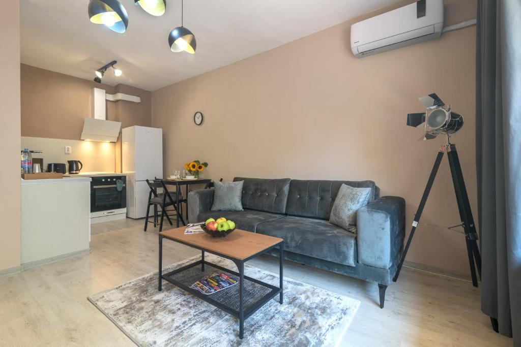 a living room with a couch and a table at WILLY-ANDON APARTMENT in Varna City