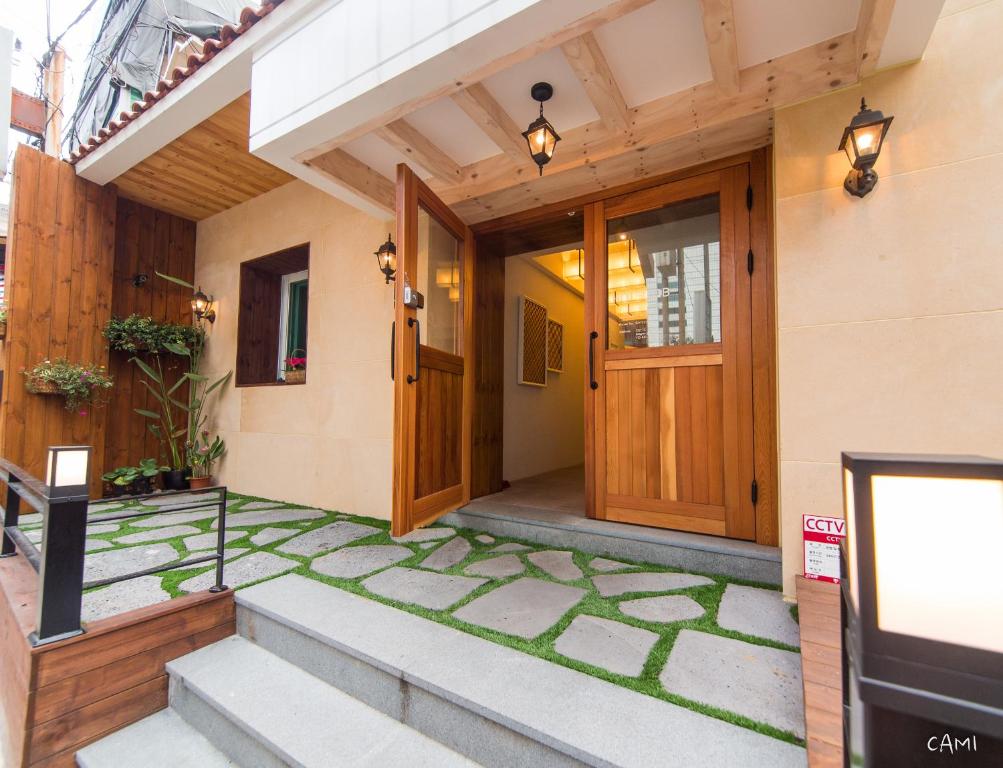 a house with a wooden door and a walkway at Hotel QB Dongdaemun Gallery in Seoul