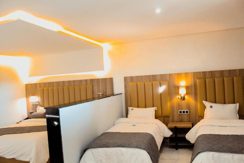 Postel nebo postele na pokoji v ubytování Hôtel La Perla