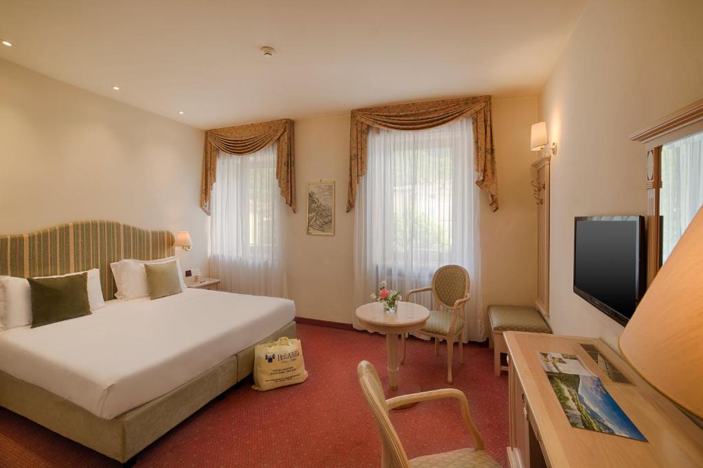 a hotel room with a bed and a television at Bellavista Relax Hotel in Levico Terme