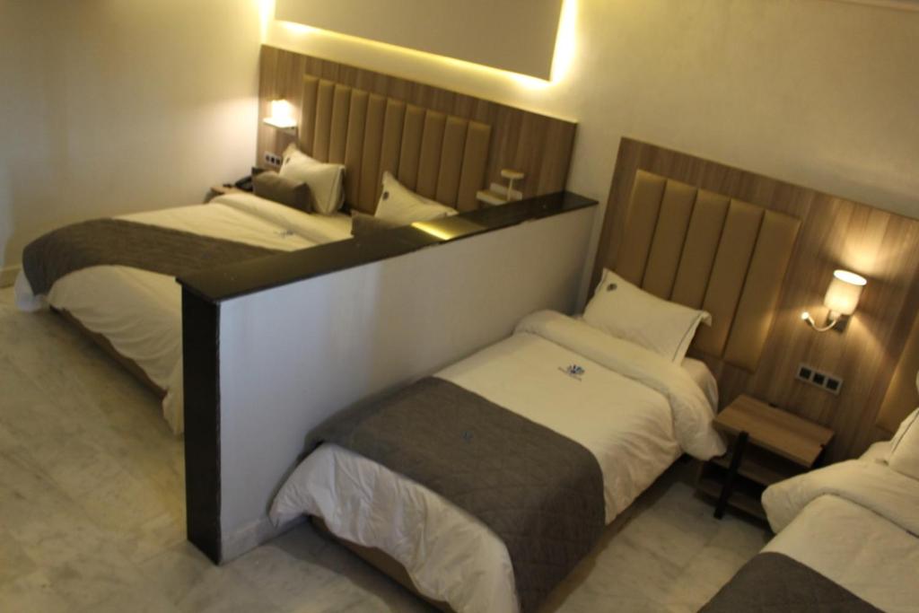 Postel nebo postele na pokoji v ubytování Hôtel La Perla