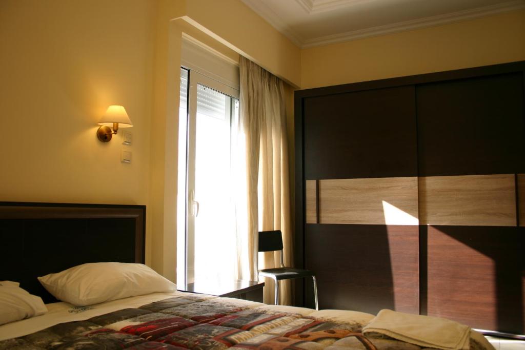 Postel nebo postele na pokoji v ubytování Petit Palais Hotel