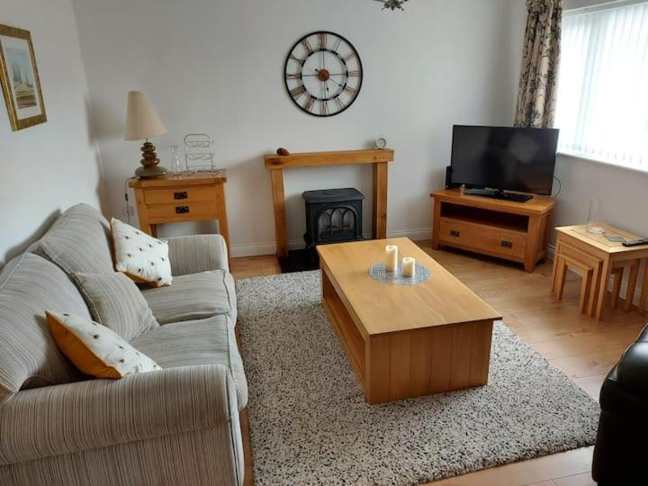 a living room with a couch and a coffee table at Detached 2 bedroomed bungalow Billingham Stockton on Tees in Stockton-on-Tees