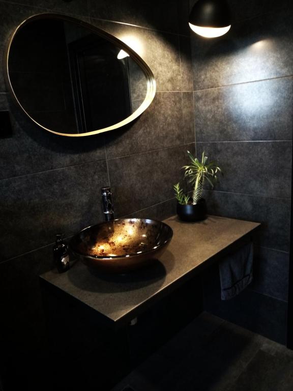 a bathroom with a bowl sink and a mirror at House of Silence in Trogir