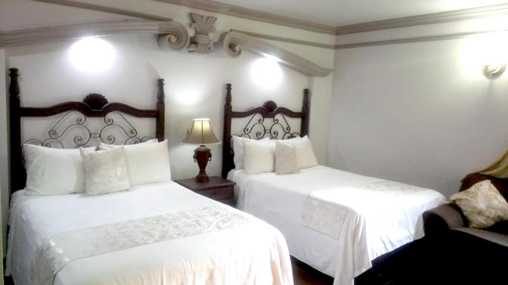Postel nebo postele na pokoji v ubytování Hotel Hacienda los Narcisos