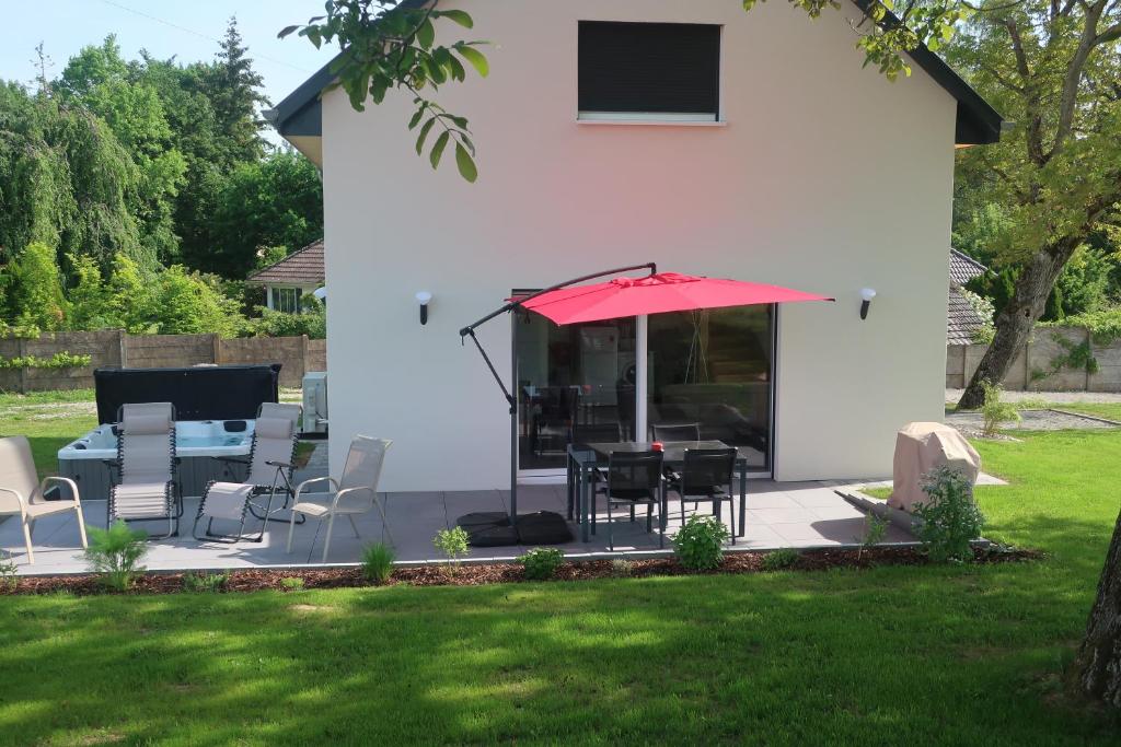 a patio with a table and chairs and an umbrella at gîte les bouleaux in Carspach