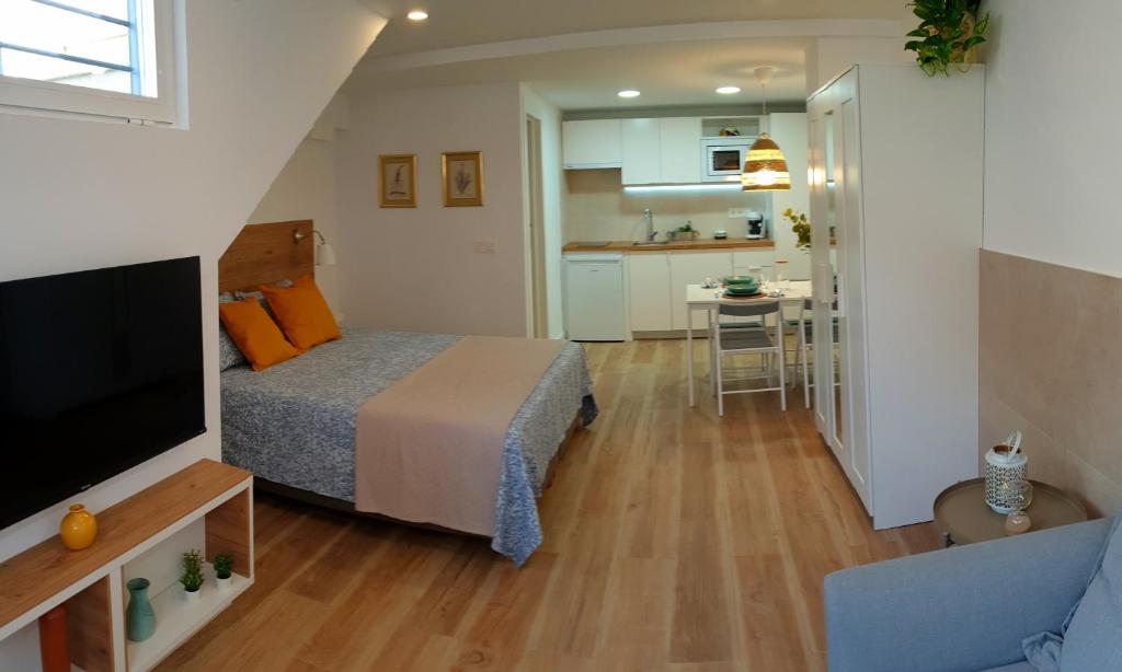 um pequeno quarto com uma cama e uma cozinha em Road Sierra 95 Habitación privada con baño y zona de cocina em Granada