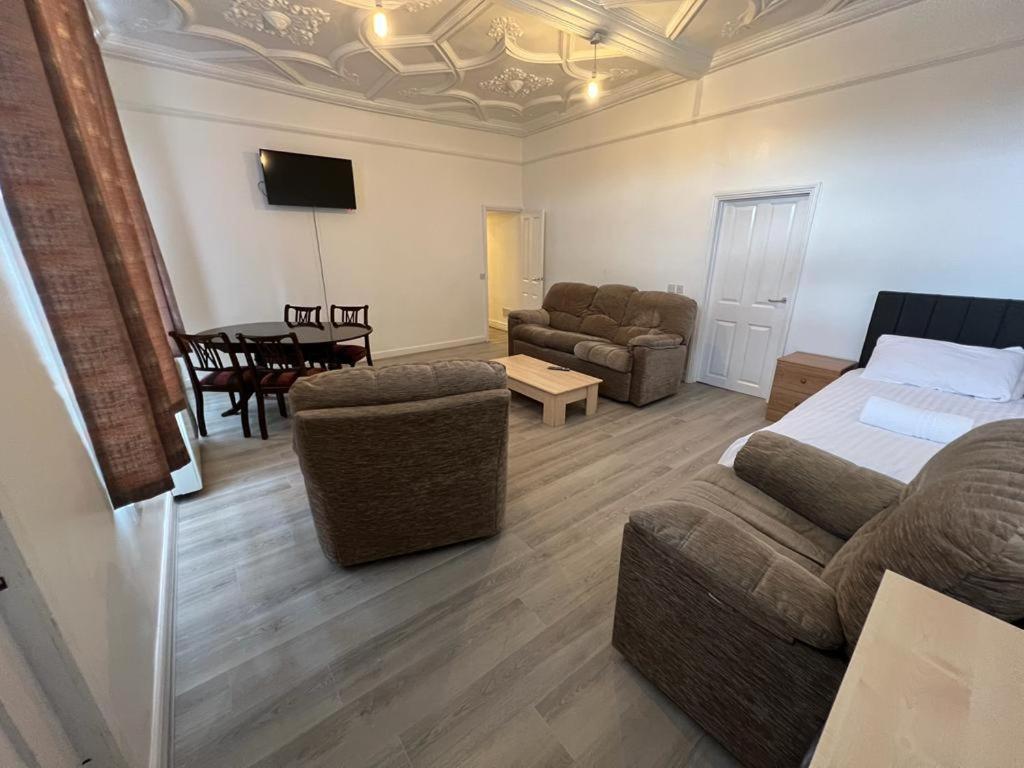 a living room with a bed and a couch and a table at Spacious Entire Flat, 1 in Great Yarmouth