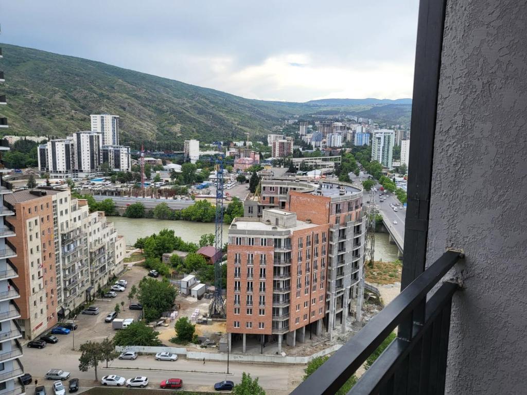 a view of a city from a balcony at New stylish 2 bedroom - Apartment in New building in Tbilisi City