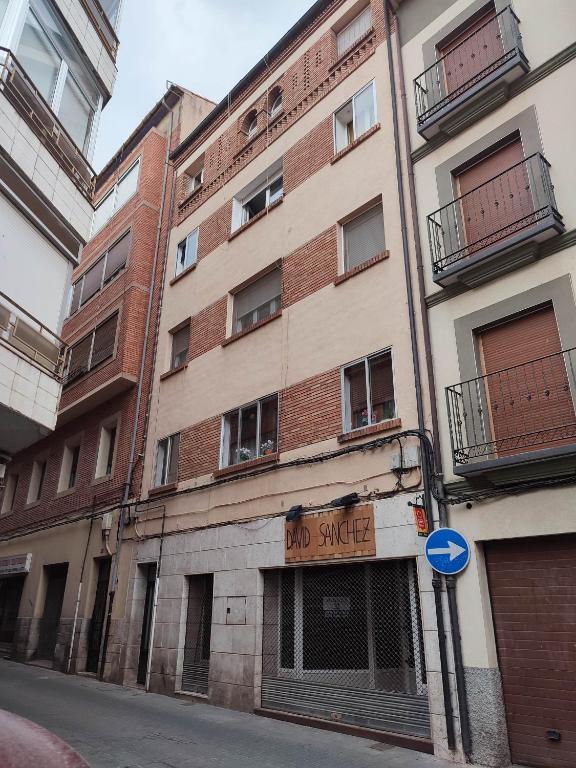 an old brick building with a no garage sign on it at San Andres 14 in Teruel