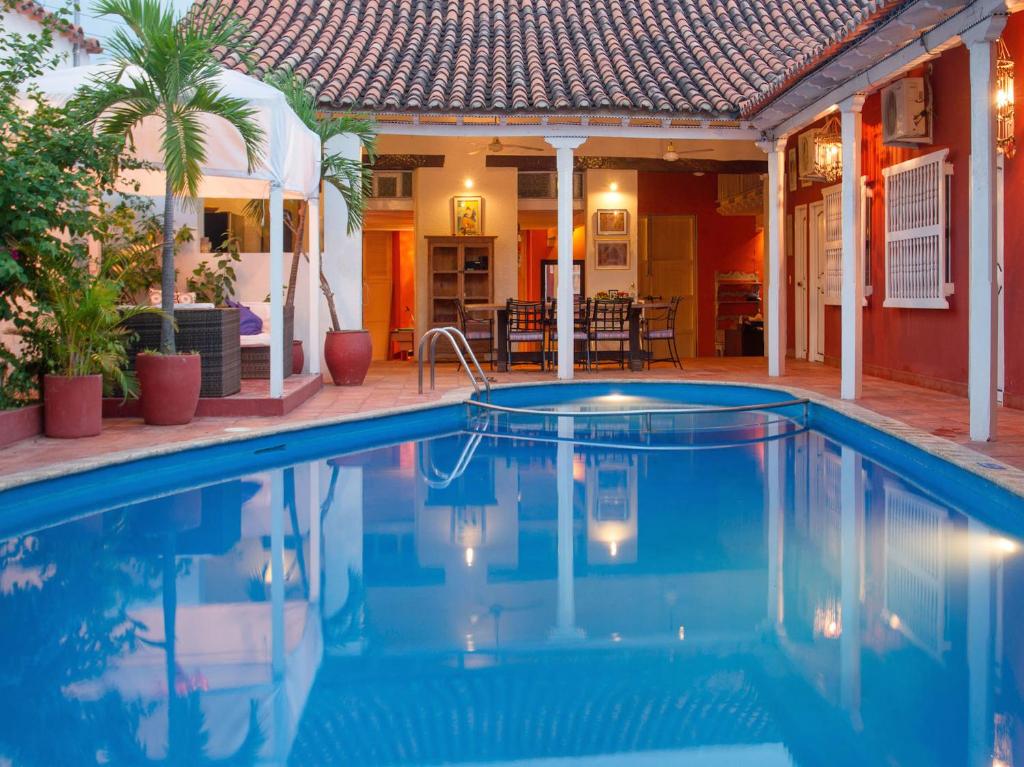 a swimming pool in front of a house at Casa Relax Hotel in Cartagena de Indias
