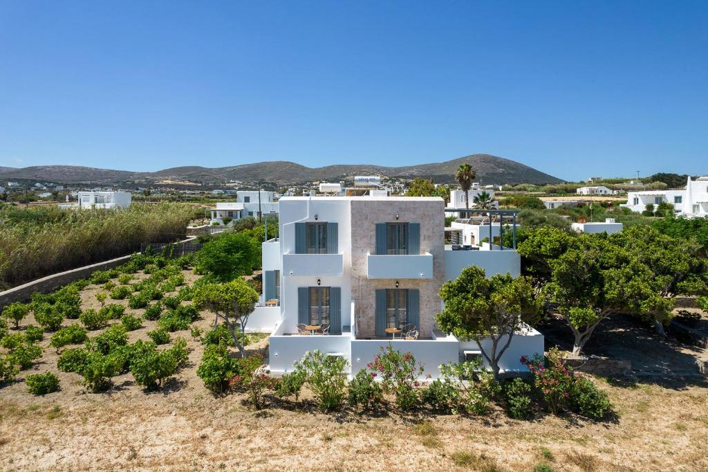 uma vista para uma casa branca com árvores em Anna Studios Paros em Naousa