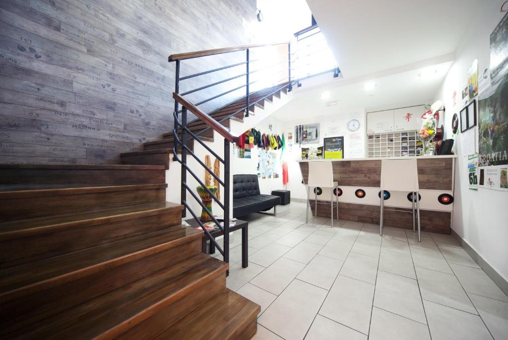 a lobby of a store with wooden stairs at Funk Lounge Hostel in Zagreb