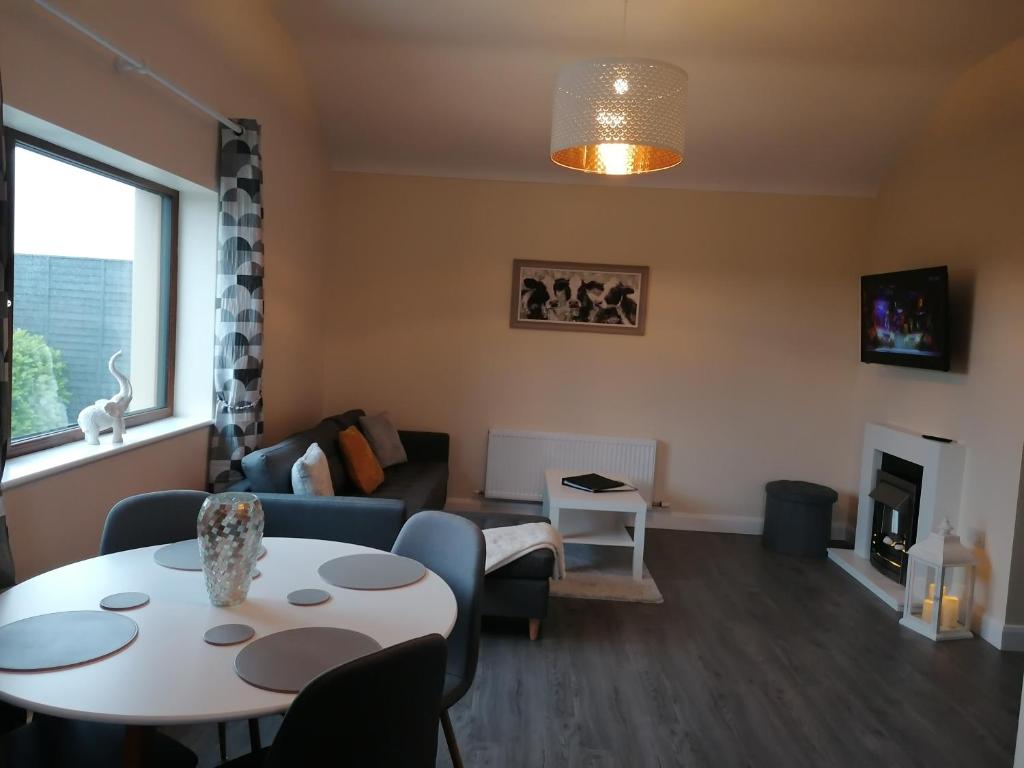 a living room with a table and a couch at Atlantic way Apartment in Sligo