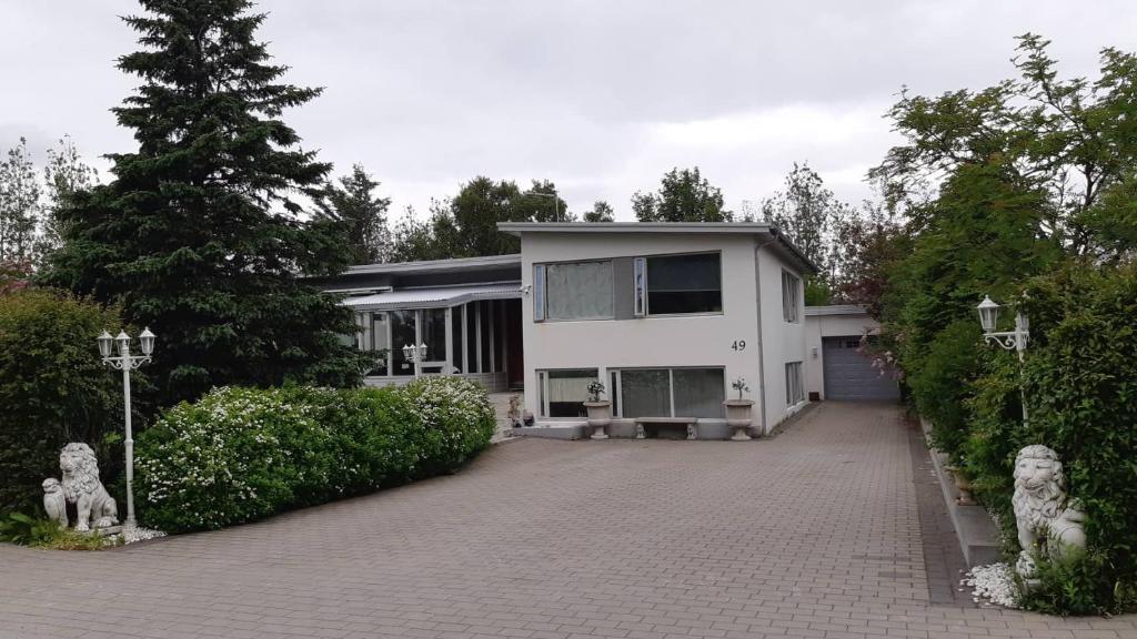 a large white house with a driveway at Selfoss Apartment in Selfoss