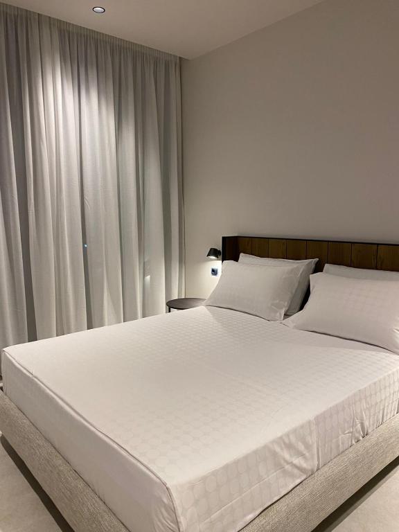 Postel nebo postele na pokoji v ubytování Hotel Olympia Touristic Village