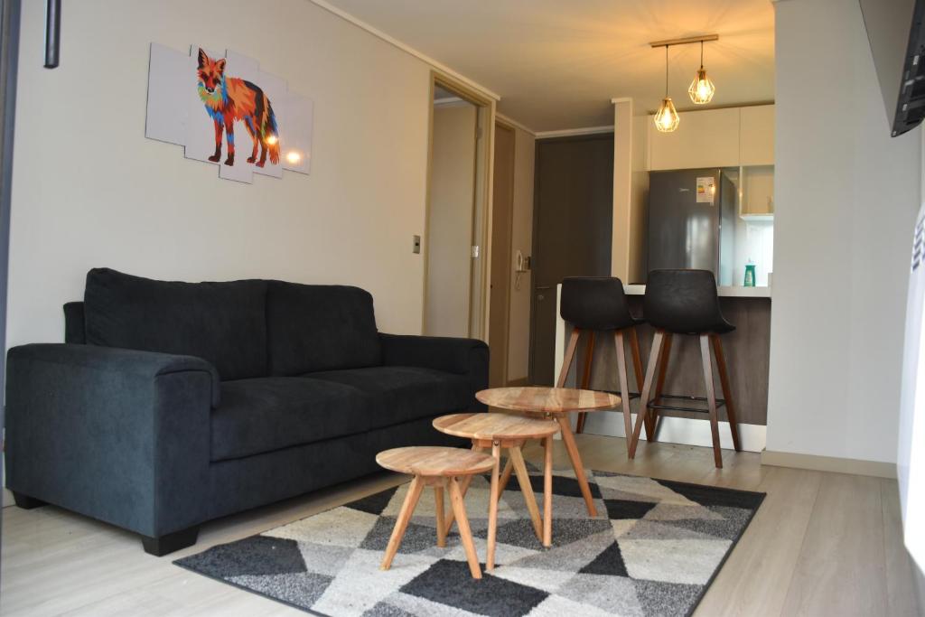 a living room with a couch and a table at The Fox Departamentos in Santiago