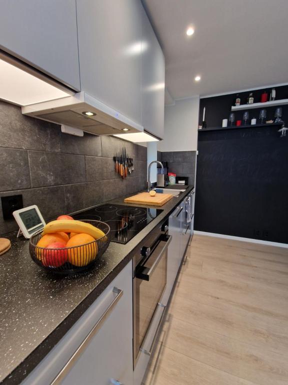 a kitchen with a bowl of fruit on a counter at Ibsens in Bergen