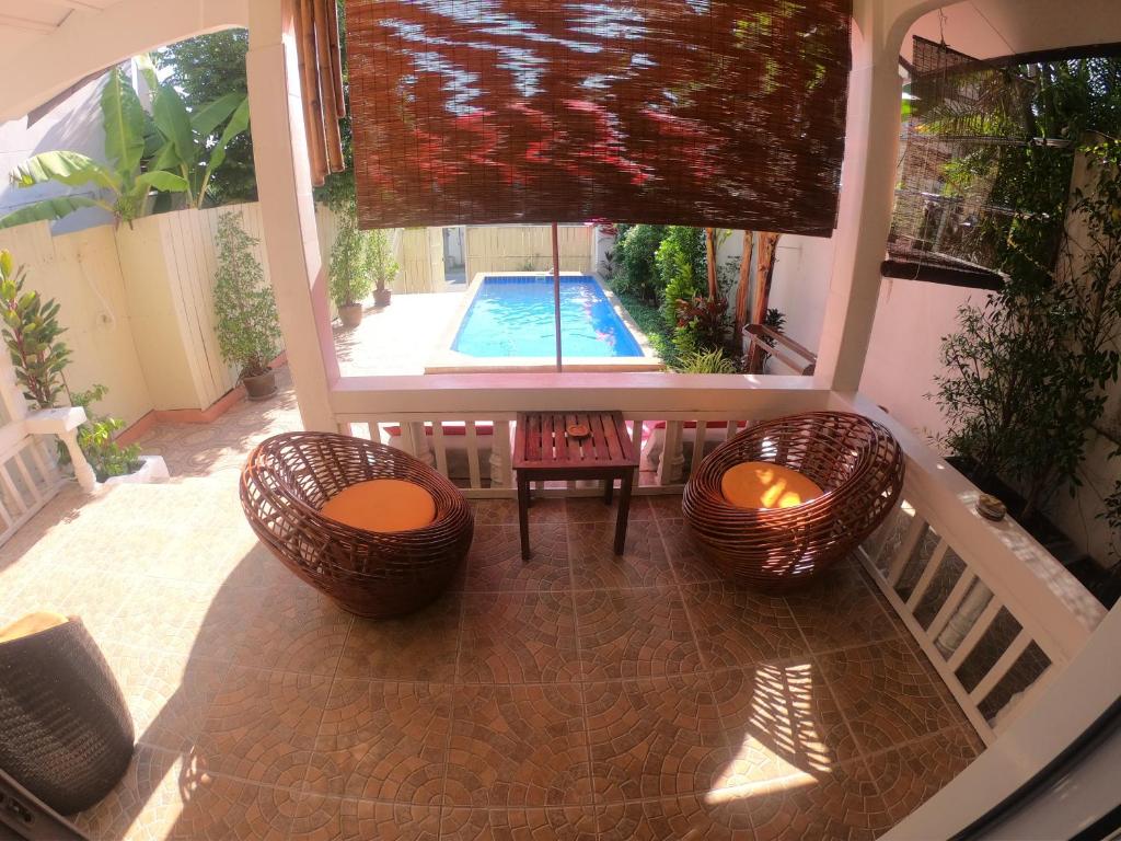 a view of a patio with two chairs and a pool at Lamai villa in Lamai