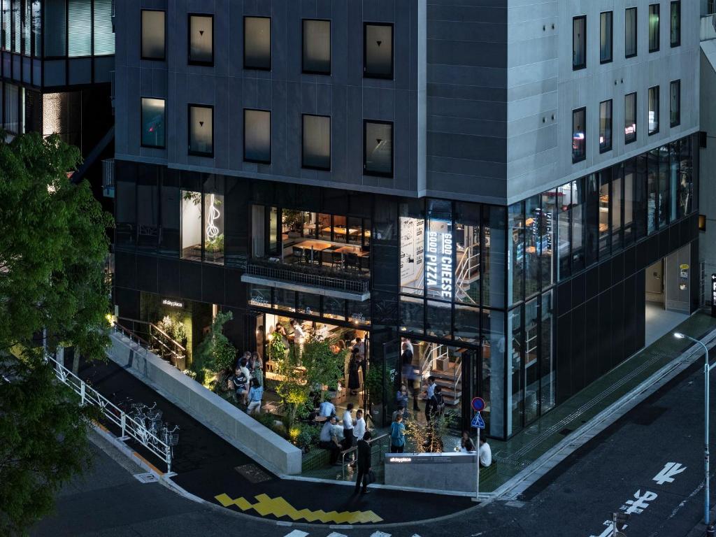 an overhead view of a building with people in it at all day place shibuya in Tokyo