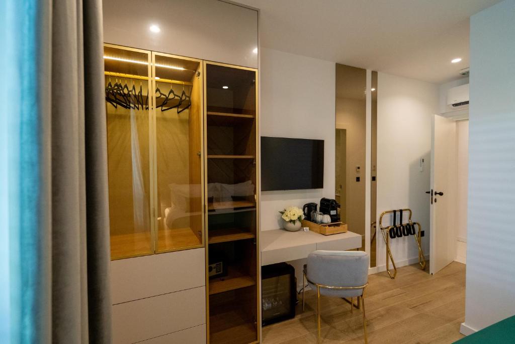 Televízia a/alebo spoločenská miestnosť v ubytovaní Amélie Luxury Rooms