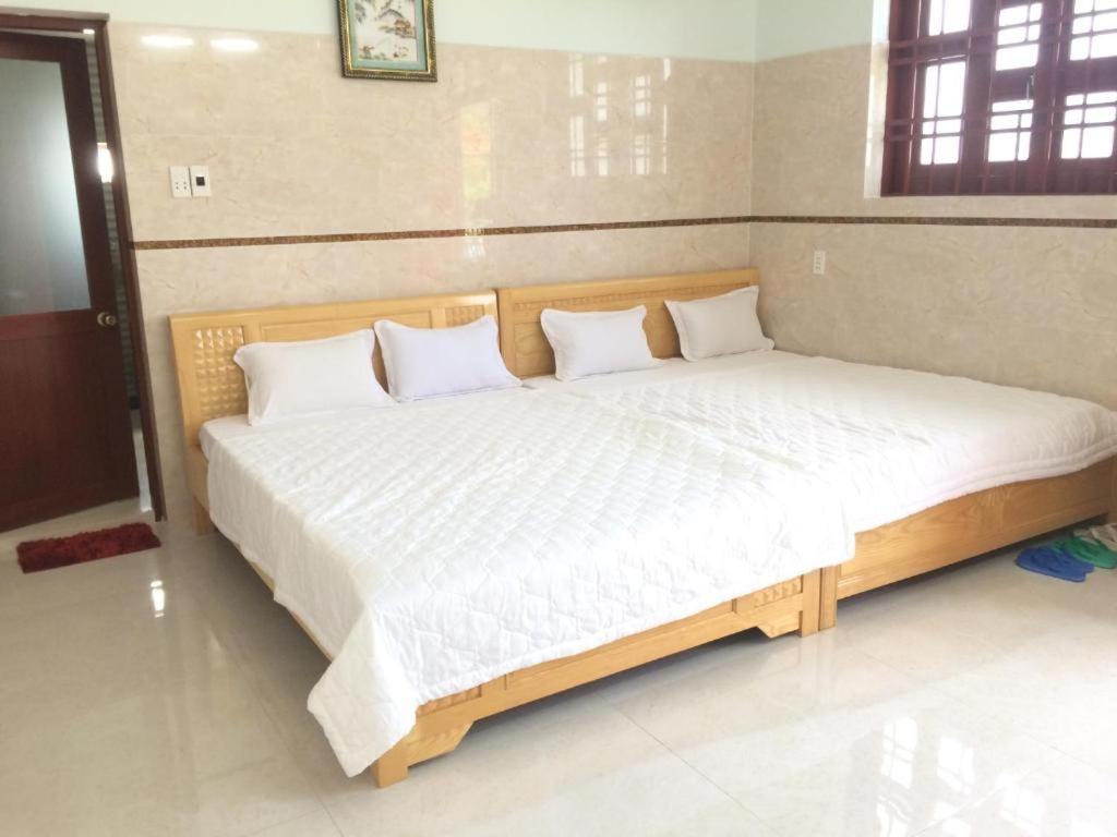 Voodi või voodid majutusasutuse Nhà Nghỉ Nguyên Anh toas